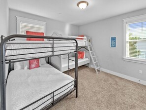 A bunk bed room with a ladder, a desk, and a window with blinds. - Golf Cart & 4 Bikes! Steps to Pool! Bike to Beach! King Master & 2 Sets of Bunks! ~ Coconut Cottage in Highland Parks on 30A (Santa Rosa Beach)
