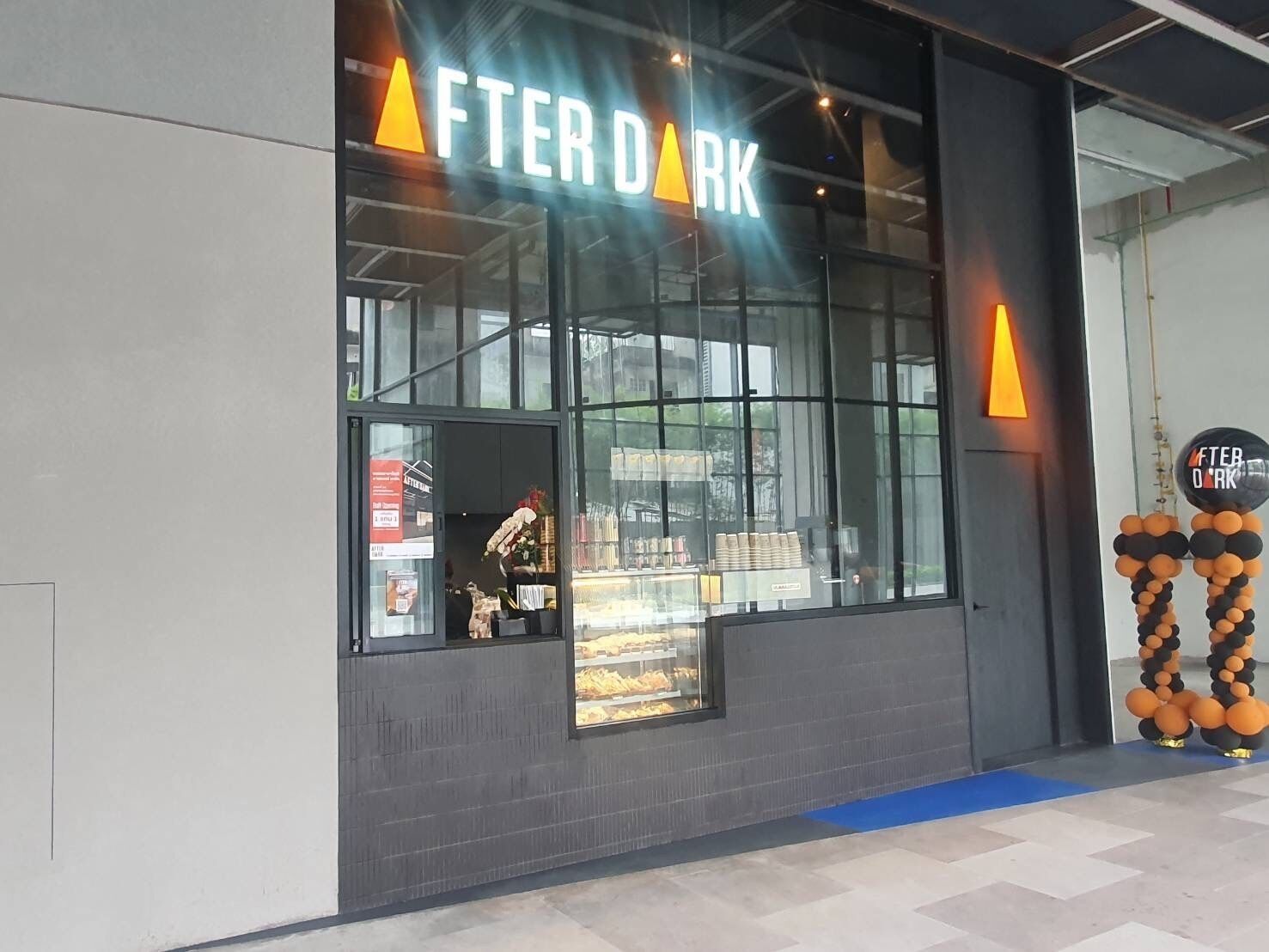 A modern building with a sign reading "AFTER DARK".