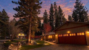 A two-story house with a red garage door, a stone pathway leading to the entrance, and a well-maintained lawn. - Tahoe Retreat AC Hot Tub Backyard Oasis, Near Skiing & Beaches (SL397) (Stateline)