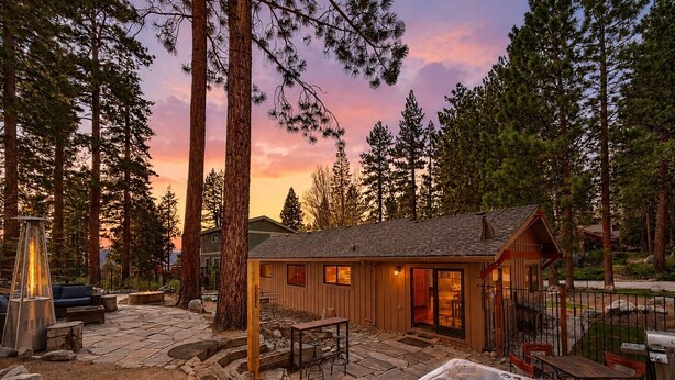 A cabin with a hot tub, outdoor seating, and a stone patio. - Tahoe Retreat AC Hot Tub Backyard Oasis, Near Skiing & Beaches (SL397) (Stateline)