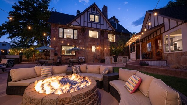 A stone house with a fire pit and outdoor seating. - The Beatrice Estate 7 Bedroom Estate (Grand Junction)