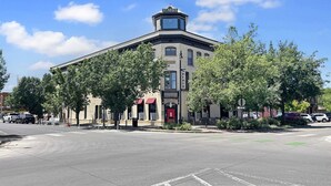 A historic building with a prominent tower, large windows, and a red awning. - The Loft Of Historic Charm 1 Bedroom Condo (Grand Junction)