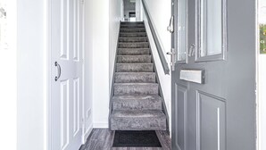 A staircase with carpeted steps leading to a landing. - Prime Commuters Choice Award by Three Bridges Apartments (Pitreavie Castle)