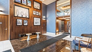 Eine moderne Lobby mit Holzvertäfelung, Marmorböden und einem Empfangstresen.