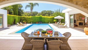 A pool area with a table set for dining, surrounded by lounge chairs. - Villa Zoey - Three Bedroom Villa, Sleeps 6 (Theletra)