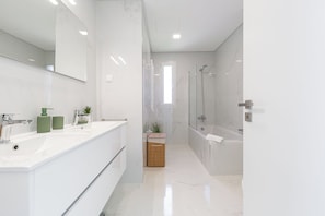 Shower, hair dryer, towels, toilet paper
