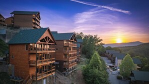A multi-story wooden lodge with balconies and a view of the sunset. - *Gorgeous 3BD Cabin w/ VIEWS! Hot Tub + Games!* (Sevierville)