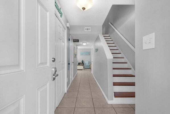 A hallway with a staircase leading to a living area. - 🐾 Pet Friendly 🌅Walk2Beach-Southbay #32 (Destin)