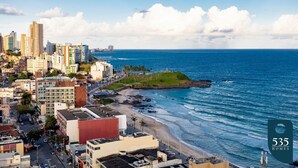 Un paisaje urbano costero con rascacielos, una playa y el océano.