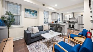 A modern apartment with a living room, kitchen, and dining area. - New Spacious 3 Bedroom Apt in the Heart of Philly (Philadelphia)