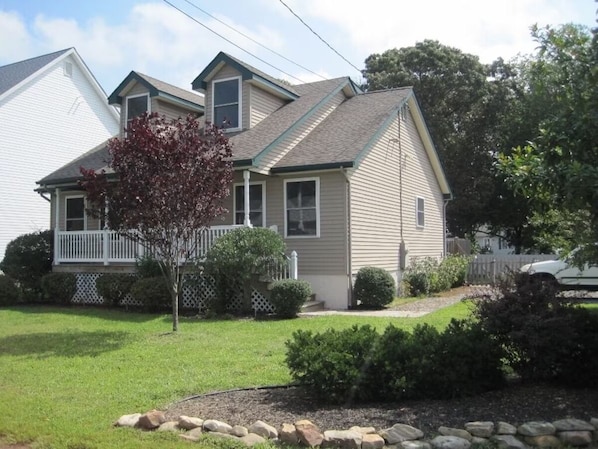 A two-story house with a front porch, a small tree, and a well-maintained lawn. - Cape May-1 block to Delaware Bay beach, sleeps 10 and pet friendly (Middle Township)