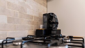 A kitchen with a modern gas stove and a coffee maker. - Entire apartment in the center of Palermo (Palermo)