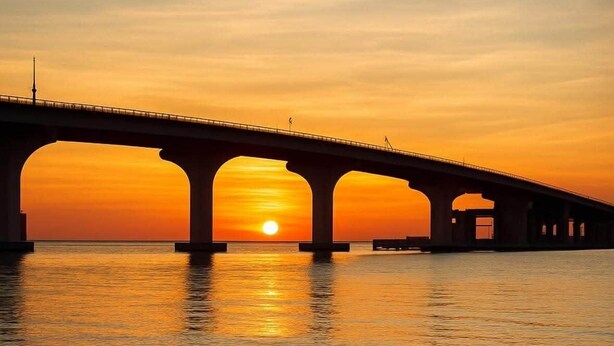A bridge over water with a bird standing on the shore. - #803 Lovers Key Beach Club Ocean Views (Bonita Springs)
