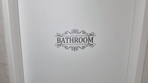 A white door with a black handle and the word "BATHROOM" written on it. - U-Rim Stay (Seoul)