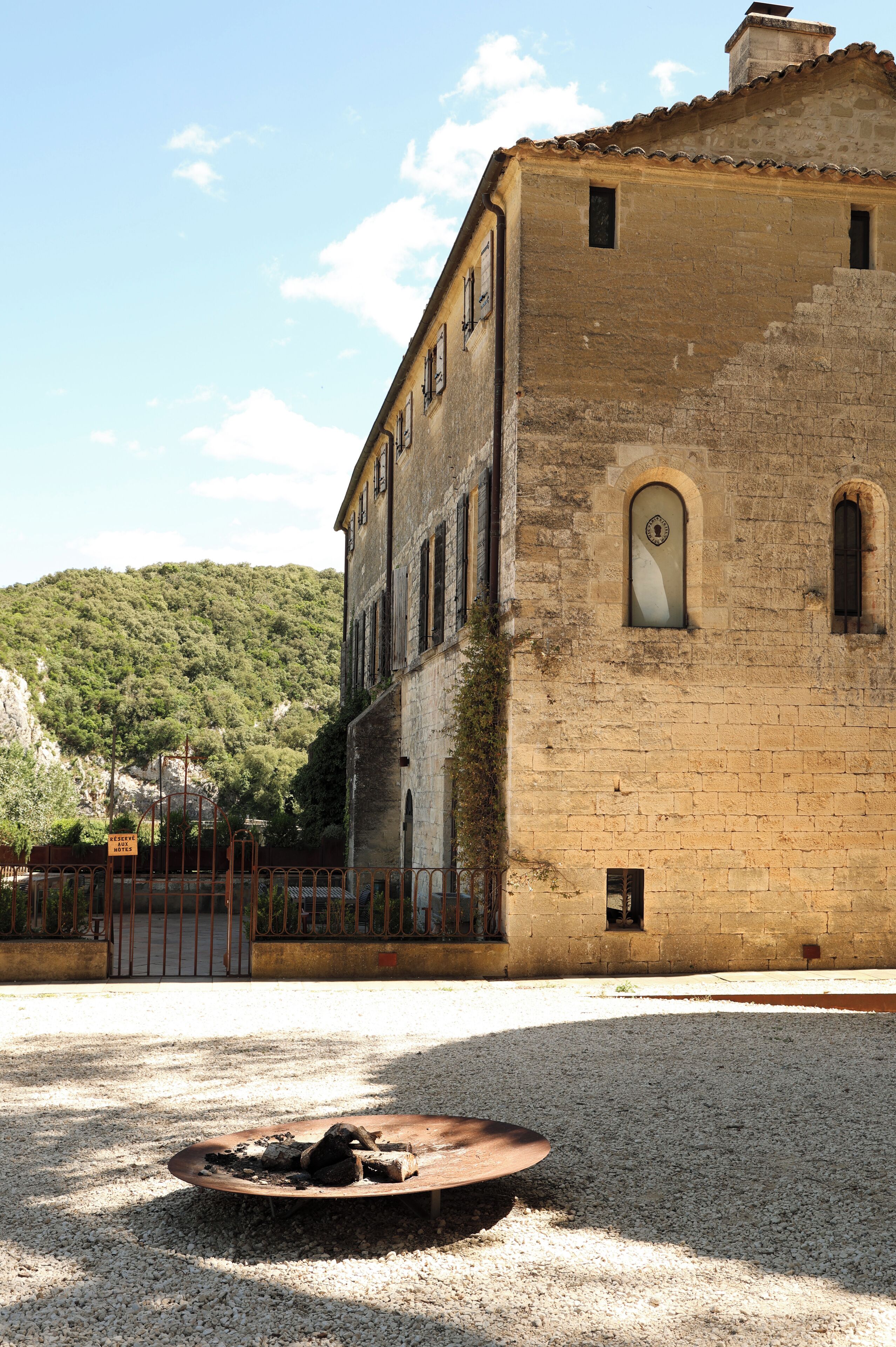 A historic building with a courtyard and a fire pit.