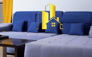 A modern living room with a sofa and a coffee table. - Stunning Villa  (Ouagadougou)