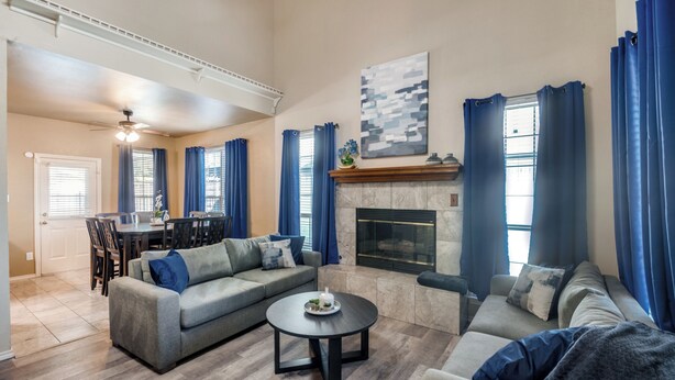 A spacious living room with a fireplace, a dining area, and a sofa set. - 4 Bedroom & Pool: Great Irving Location close to attractions (Irving)