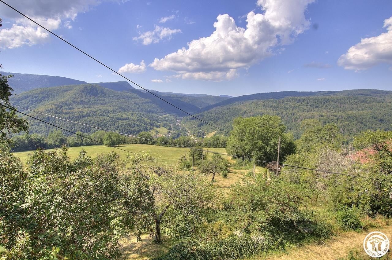 A mountainous landscape with a clear sky and power lines.
