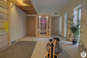 Enter a spacious room with a large window and open shelving unit.