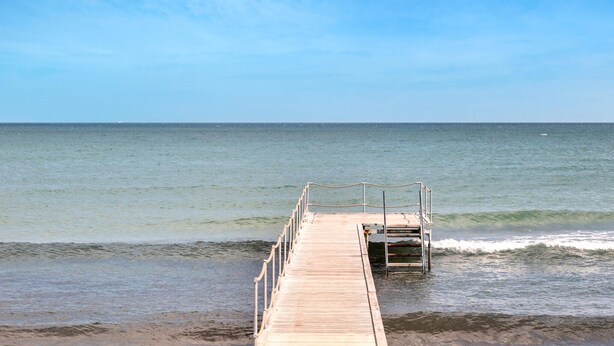 A wooden pier extending into calm waters with a clear sky above. - Nice home in Nykøbing Sj with WiFi (Nykøbing Sj)