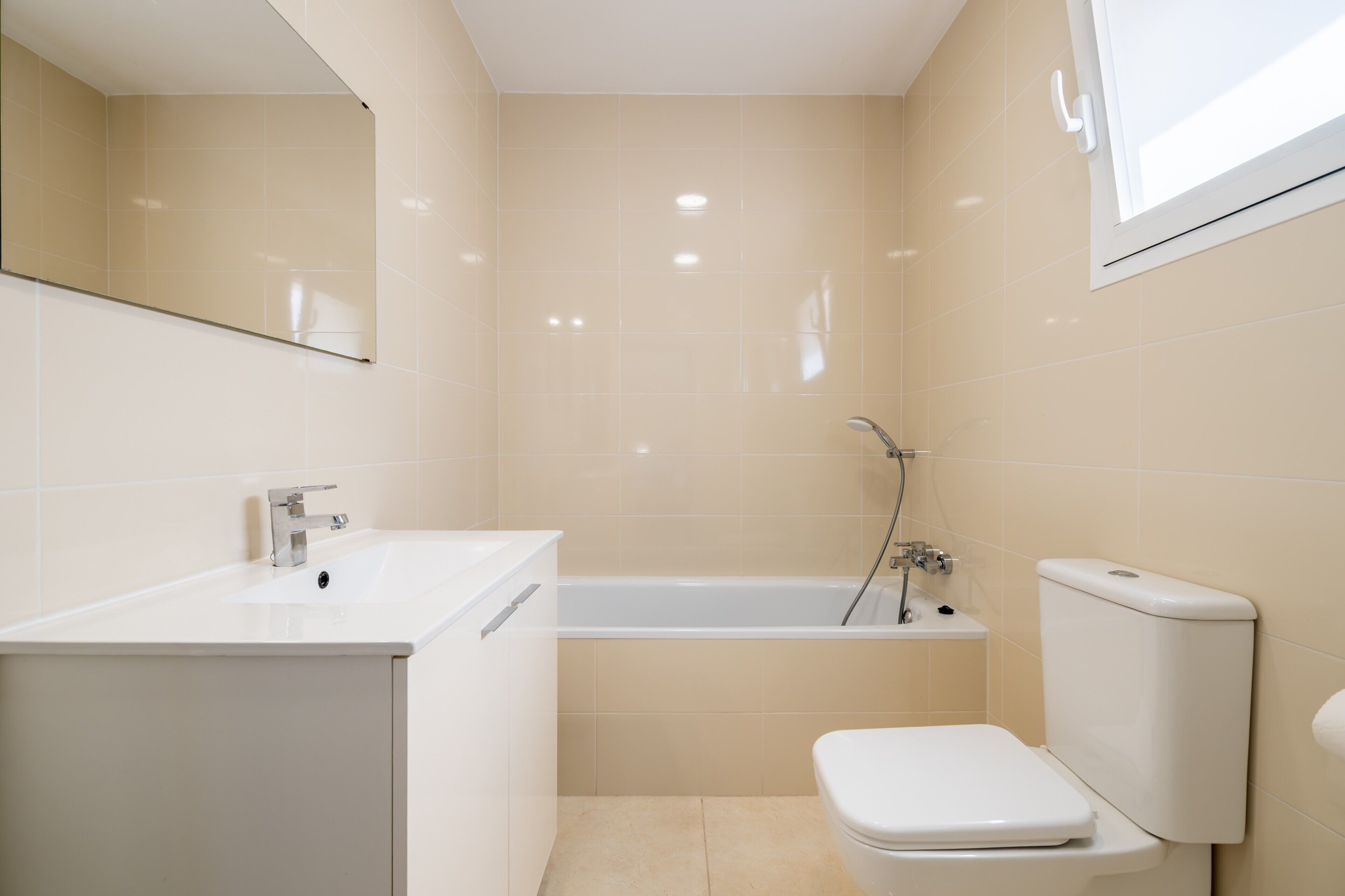 A bathroom with a sink, toilet, and bathtub.