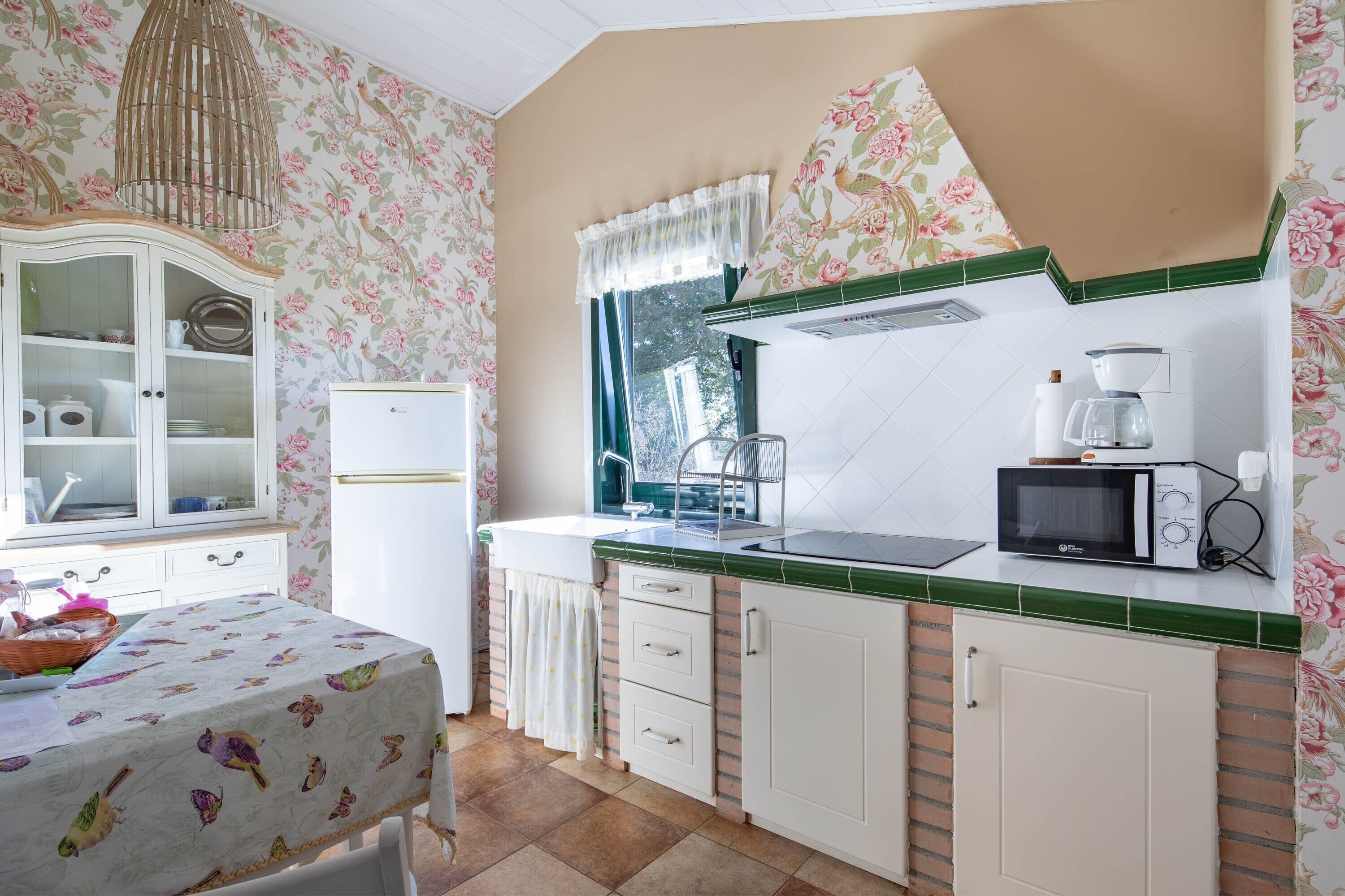 Fridge, microwave, coffee/tea maker, cookware/dishes/utensils