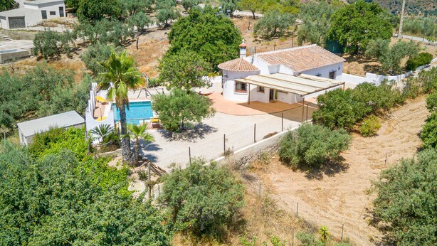 A residential property with a swimming pool, a patio, and a view of the surrounding landscape.