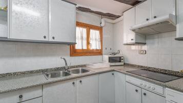 Een koelkast, een magnetron, een kookplaat, een vaatwasser