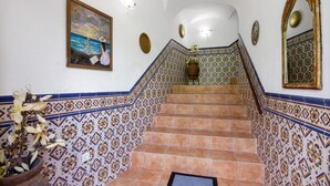 A staircase with patterned tiles, a framed painting, and a mirror. - Holiday Home 'Solar Da Tirosa' with Private Pool, Private Terrace and Wi-Fi (Boliqueime)