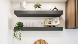 A kitchen with white cabinets, black handles, a wooden cutting board, a hanging plant, and a shelf with decorative items. - Mesa Retreat Quiet, Stylish Desert Escape + Golf (Mesa)
