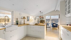 A modern kitchen with white cabinetry, a wooden countertop, and a view to the outside. - Beautiful home in ølsted with WiFi (Ølsted)