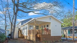 A single-story house with a porch, a small deck, and a visible mailbox. - 1309 Ocean Lakes Pet Friendly Golf Cart⛱️🏝️🩱🌊👙☀️🐚 (Myrtle Beach)