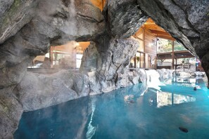 A hot spring pool with a wooden cabin in the background. - Snowline Lodge with Indoor Pool, Pickleball, Hot Tub and Disc Golf! (Camino)