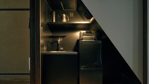 A compact kitchen with a built-in coffee maker, a toaster, and a refrigerator. - YADORU KYOTO HANARE Shirotaki No Yado (Kyoto)