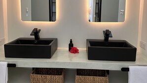 A modern bathroom with two black sinks, mirrored above each, and hanging pendant lights. - Luxury villa in a magnificent natural setting, close to the beach, infinity pool, Ayurveda spa, chef,  (Ahungalla)