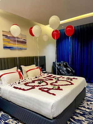 A hotel room with a bed, pillows, a massage chair, and balloons. - qimampark AlNamas6 (Al Namas)