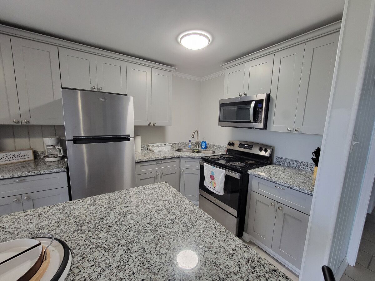 Fridge, microwave, coffee/tea maker, cookware/dishes/utensils