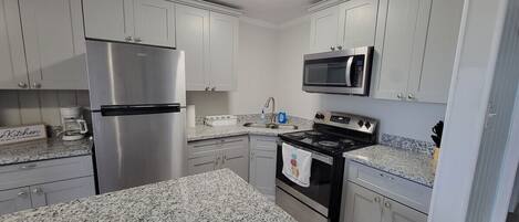 Fridge, microwave, coffee/tea maker, cookware/dishes/utensils