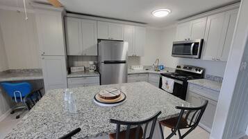 Fridge, microwave, coffee/tea maker, cookware/dishes/utensils