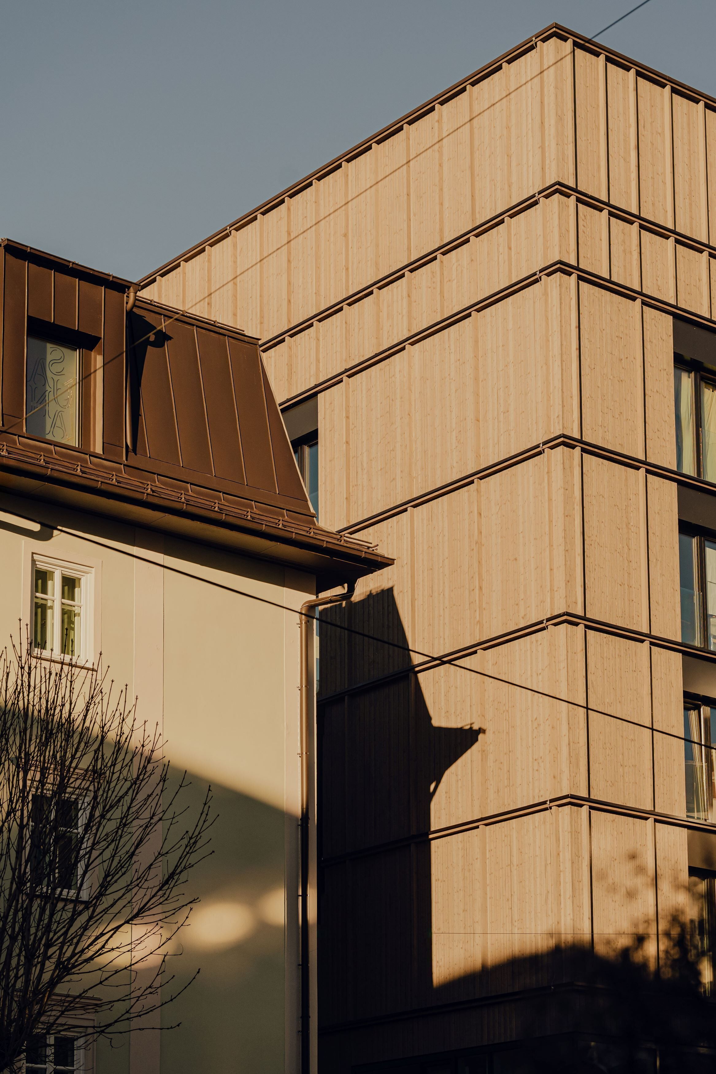 A modern building with a flat roof and large windows.