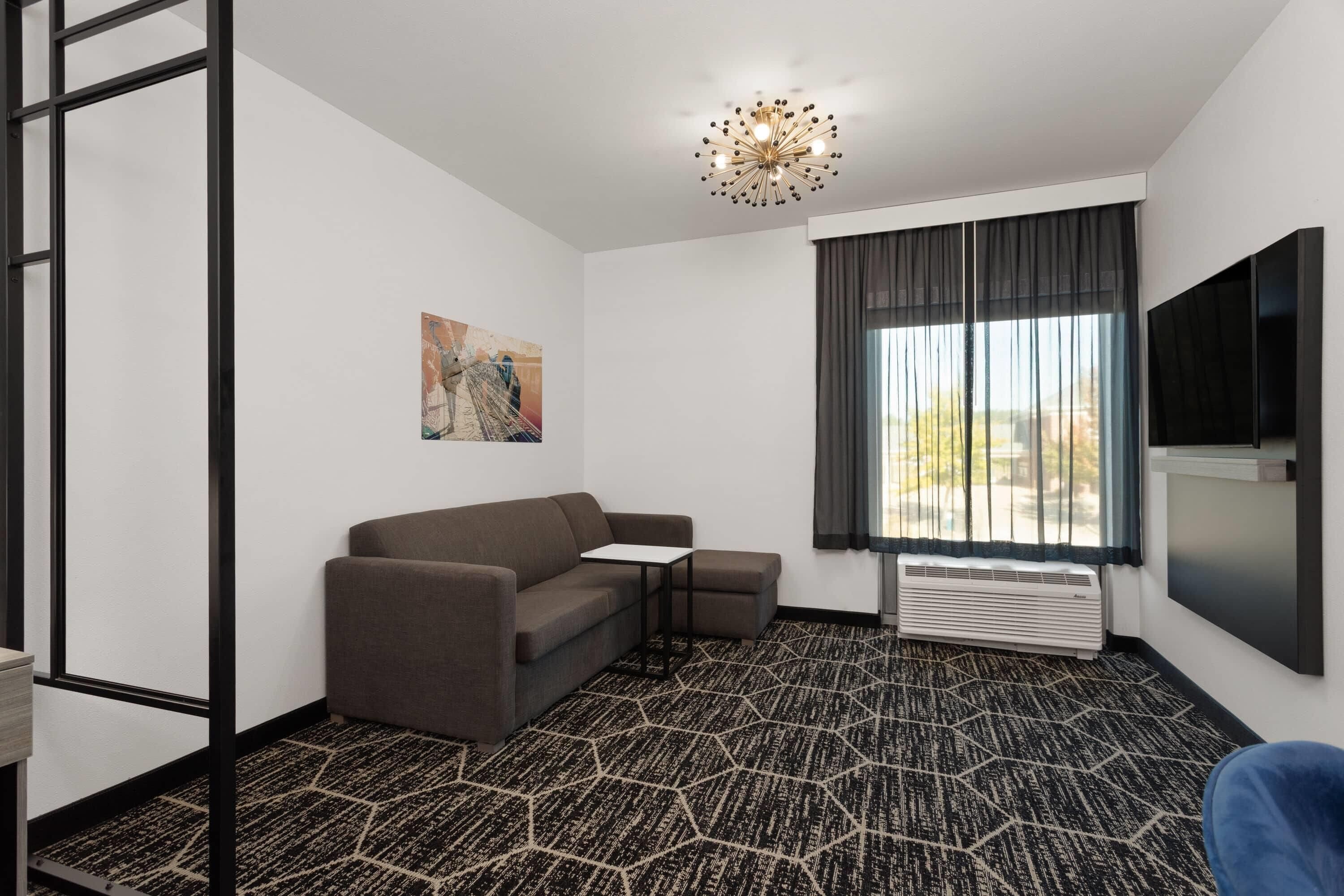 Suite, 1 King Bed, Non Smoking | Desk, laptop workspace, blackout drapes, iron/ironing board