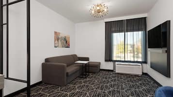 Suite, 1 King Bed, Non Smoking | Desk, laptop workspace, blackout drapes, iron/ironing board