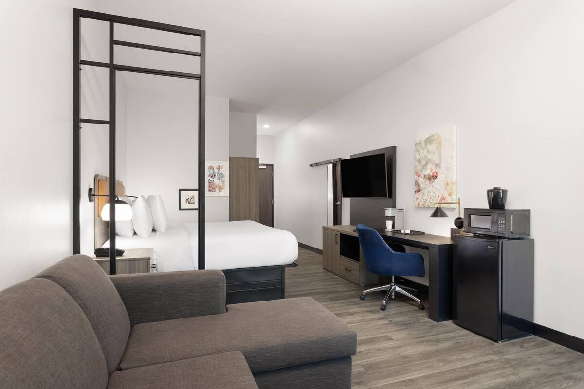 Suite, 1 King Bed with Sofa bed, Accessible, Non Smoking (Mobility, Tub w/ Grab Bars) | Desk, laptop workspace, blackout drapes, iron/ironing board