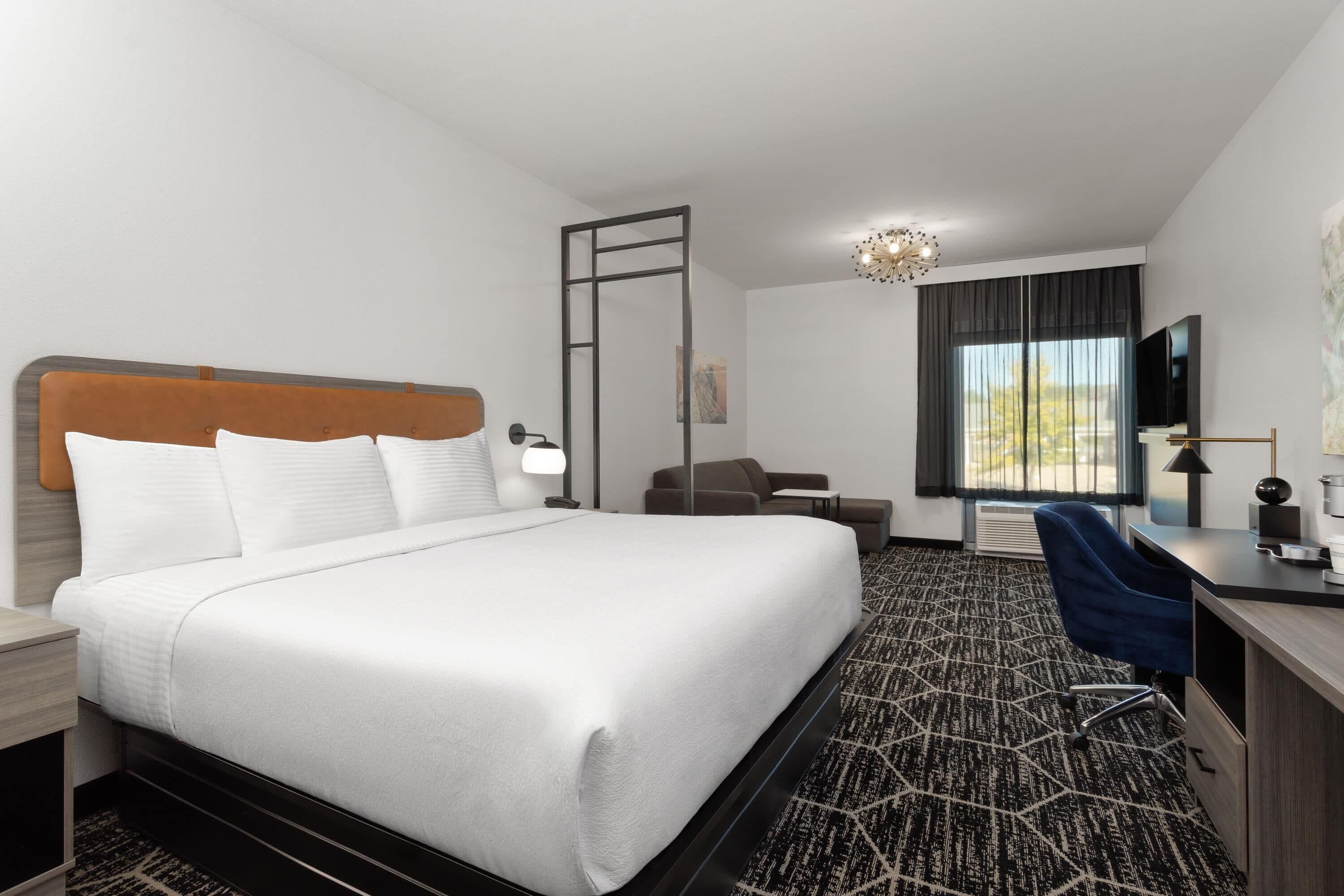 Suite, 1 King Bed, Non Smoking | Desk, laptop workspace, blackout drapes, iron/ironing board