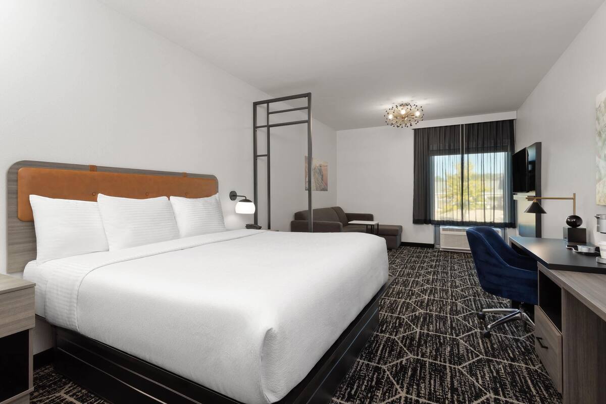 Suite, 1 King Bed, Non Smoking | Desk, laptop workspace, blackout drapes, iron/ironing board