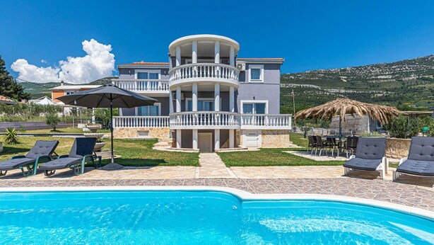 A two-story building with a pool in the foreground. - Exquisite Spacious Villa Bufaline With Pool and Gym (Kastela)