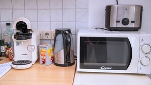 A kitchen with a coffee maker, toaster, and microwave. - Comfortable single room with shared bathroom  (Plauen)