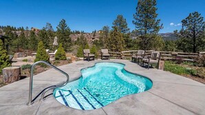 A swimming pool with a wooden deck, lounge chairs, and a mountainous backdrop. - Pool, Hot Tub, Tennis and Golf, Amazing Views! (Durango)