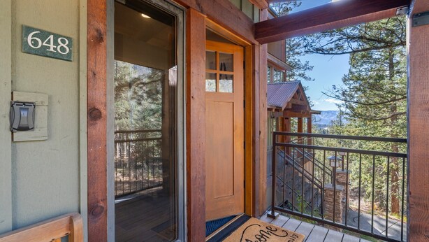 A wooden front door with a number sign, a welcome mat, and a balcony with a view of trees and mountains. - Pool, Hot Tub, Tennis and Golf, Amazing Views! (Durango)