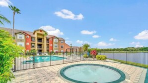 Un hotel con piscina, vasca idromassaggio e vista sul lago.